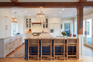Edgewater waterfront home renovation kitchen island with seating and wood beam ceiling detail